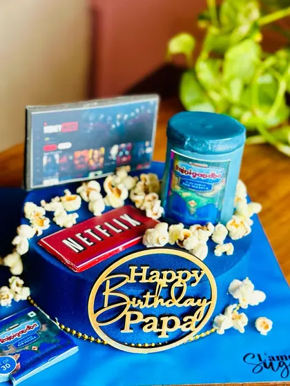 The perfect cake for a dad who loves to Netflix and chill. This fun design features an edible TV screen, popcorn, and his favorite pan masala for a truly personalized celebration.