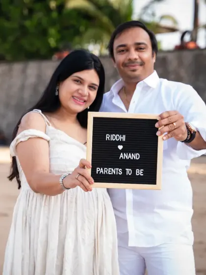 Announcing their new journey with a simple, charming letter board. This beach maternity photo is a wonderful way to share the news, with the couple dressed in white against the backdrop of the sea.