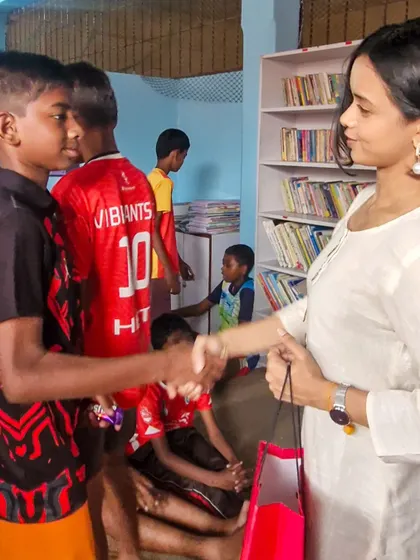A young boy shakes hands with Megha Ray, a moment of mutual respect and connection. We are so grateful for friends who use their platform to support our cause.