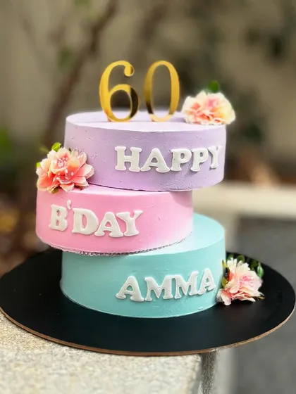 I tried the trendy criss-cross cake style for this 60th birthday cake for a mother. The three separate tiers in pastel colors create a unique and modern look.