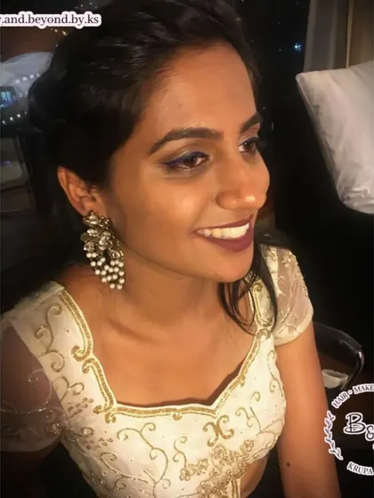 A closer look at the soft glam makeup for this wedding guest. You can see the subtle definition of the blue eyeliner and the beautiful bronze tones on the skin that give a warm, radiant glow.