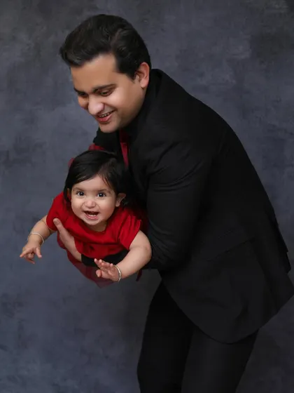 The pure joy of a father playing with his baby girl. This dynamic and happy portrait captures the special bond between a dad and his daughter.