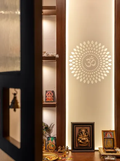 A detail of the puja unit, seen through a custom door with bells that add a gentle, melodious welcome to the sacred space.