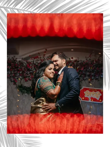 An artistic reception portrait of the couple. We used a creative framing technique to capture their embrace against the backdrop of their beautiful floral decor.