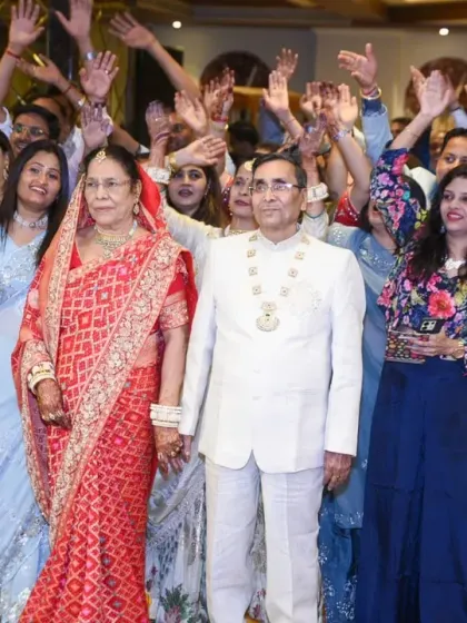 A high-energy group photo with all the guests waving and celebrating the happy couple.
