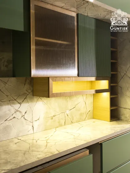 We combined fluted glass cabinets with a stunning marble backsplash to create a focal point in this kitchen. The under-cabinet lighting highlights the textures and adds a warm, inviting glow.