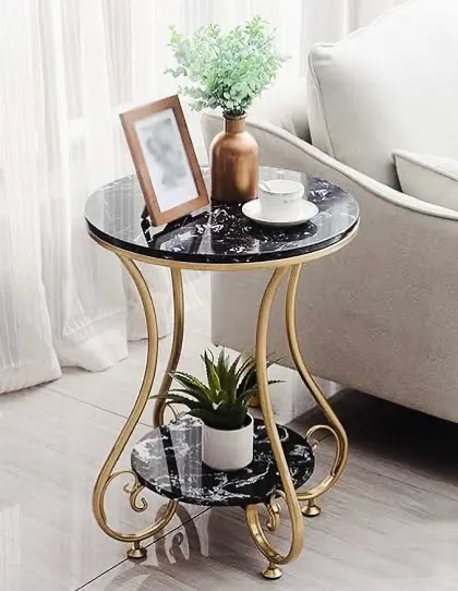 A designer coffee table featuring ornate gold-finish legs and two black marble-finish surfaces. This piece adds a touch of glamour and sophistication to any seating area.