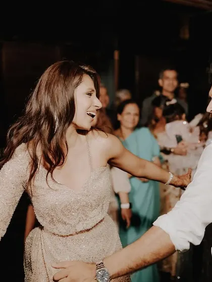 A candid shot of the couple dancing together, lost in their own world on the dance floor.