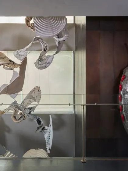 An artistic composition at the Baid Residence, where Ankon Mitra's captivating paper installation, featuring Gond art, hangs near Subodh Kerkar's symbolic chili sculptures. This pairing showcases our eclectic and bold curation style.
