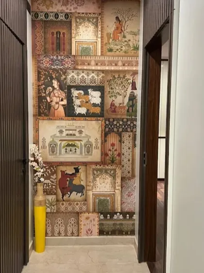 A hallway is transformed with a captivating wallpaper that collages various traditional Indian paintings and motifs, creating a journey through art and history.