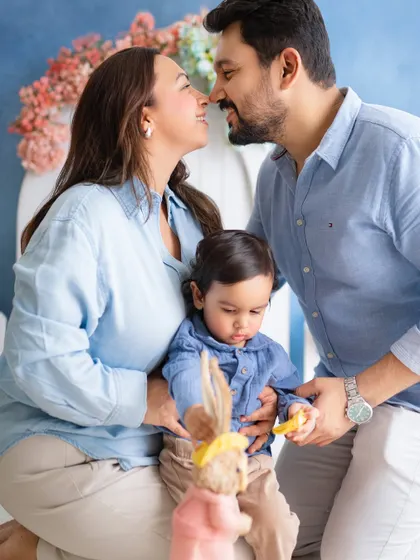 A loving moment between parents as their son plays. This photo captures the joy and intimacy of a young family.