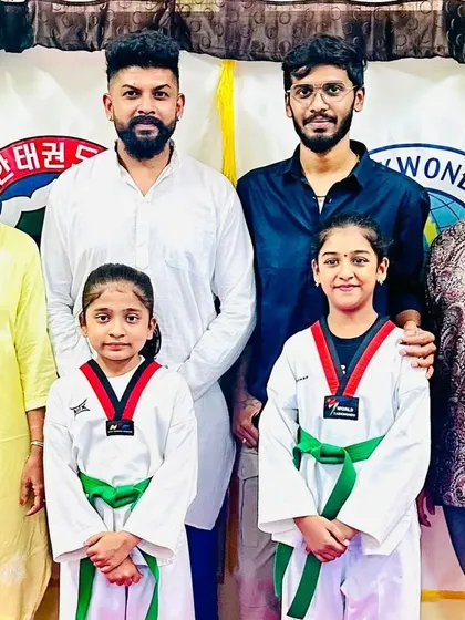A family photo celebrating their daughters' achievements.