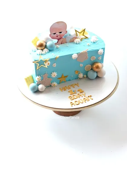 A half-birthday cake with a Boss Baby theme. This half-cut mango cake is perfect for celebrating 6 months.