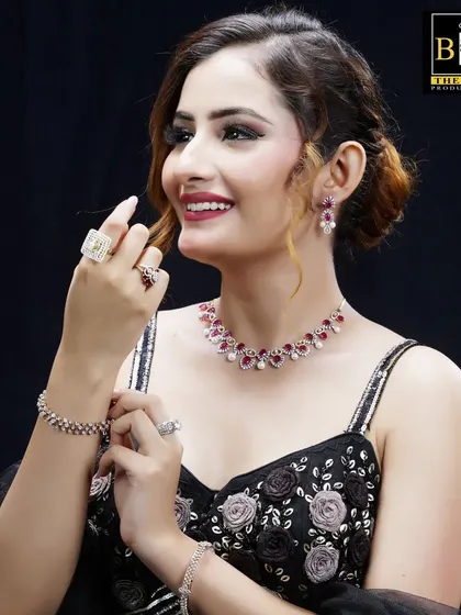 A smiling shot of the model, where the soft updo adds to the overall grace and elegance required for this high-end jewelry advertisement.