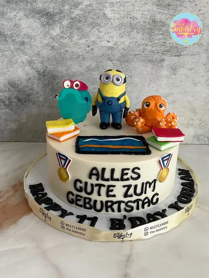Alles Gute Zum Geburtstag! A fun Minion-themed cake for an 11th birthday, featuring books, a swimming pool, and other quirky characters.