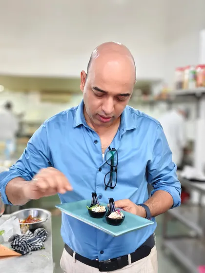 Art on a plate, crafted with passion. Here I am in the kitchen, putting the finishing touches on an appetizer, ensuring it's perfect before it goes out.