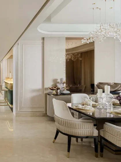 A view of one of our elegantly styled dining rooms. We focus on combining statement lighting, comfortable seating, and high-quality materials like marble and brass to create spaces that are perfect for both everyday meals and special occasions.