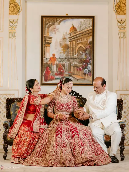 A beautiful formal portrait of the bride with her parents, a cherished family memory from the wedding day.