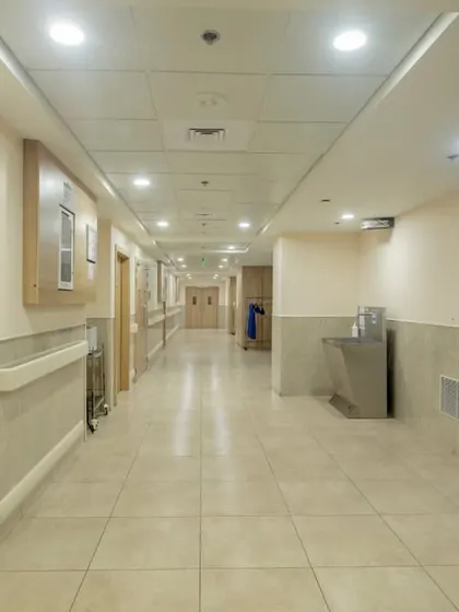 Corridors in a hospital are critical arteries. At the Ranchi Cancer Centre, we designed them to be clear and well-lit, with simple wayfinding cues like the "OT3" sign, to ensure easy navigation and reduce patient anxiety.