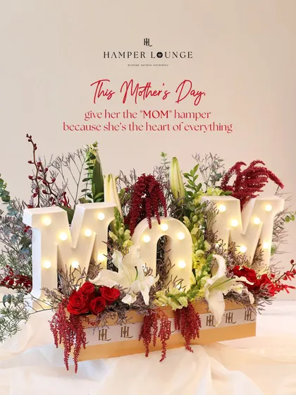 This Mother's Day, give her the "MOM" hamper. The light-up letters are surrounded by a stunning arrangement of red and white flowers, creating a tribute to her love, strength, and magic.