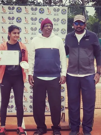The Girls Singles runner-up from the AITA TS7 U-14 tournament receives her medal and certificate.