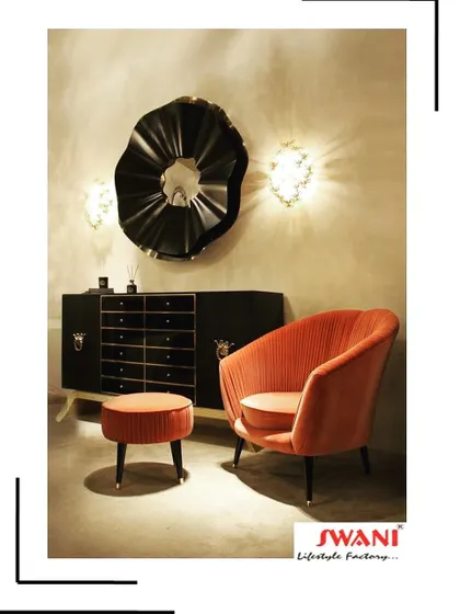 This beautiful shell-back armchair in a burnt orange fabric is paired with a matching ottoman for ultimate comfort. The pleated upholstery and tapered legs with gold tips give it a glamorous, art-deco feel that instantly elevates any room.