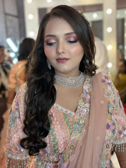 An Indo-western glam look, perfect for a reception, featuring bold pink eyeshadow and a chic hairstyle.