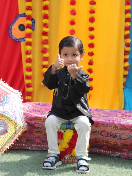 A thumbs-up for the Baisakhi fun. This little boy, dressed in a traditional kurta, is all smiles during our vibrant and educational harvest festival celebration.