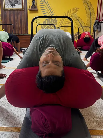Part of a de-stress sequence: Supta Virasana (Reclining Hero Pose) over bolsters. This pose opens the chest and abdomen, promoting deep, restful breathing.
