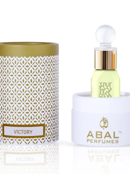 A premium attar perfume bottle shown with its cylindrical packaging, shot on white to highlight the elegant design.