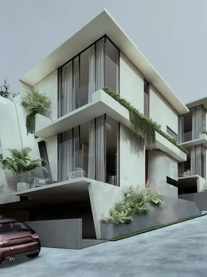 The facade of the Moira Homes features large overhangs with inbuilt planters. This design choice allows diverse greenery to become an integral part of the built scape, extending the landscape vertically along the building's exterior.
