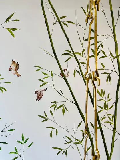 A close-up of the sparrows in the bamboo mural. Each bird is painted with care to capture its lively character as it flits between the branches.