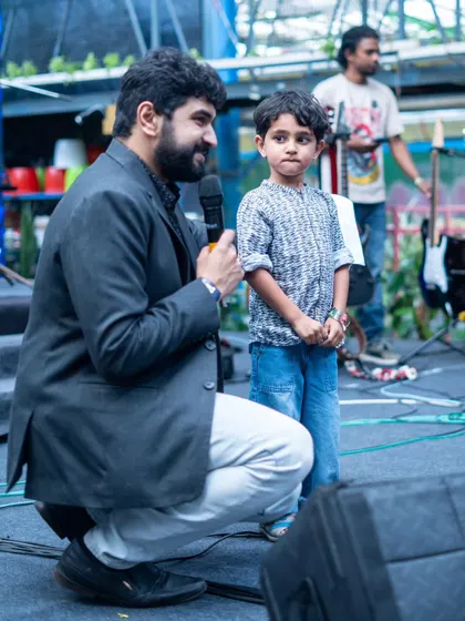 A special moment on stage where our founder interacts with one of the youngest performers. The showcase is a family event, celebrating every single student.