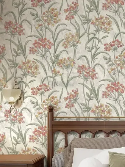 A bedroom with a vintage feel, featuring a wildflower wallpaper in soft pink and yellow tones.