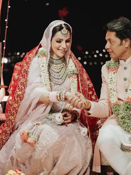 The bride shares a special moment with her father during the wedding rituals, a memory filled with love and emotion.
