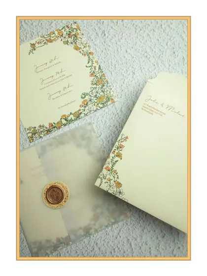 A closer look at the Dutch-Indian fusion suite, showing the vellum overlay with a wax seal and the intricate floral border on the main insert.