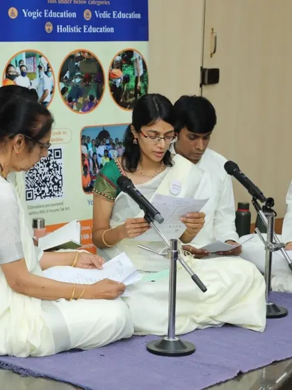 A group of students chanting together at the "Pranamami Patanjali" event, organized to honor the timeless guru of Yoga.