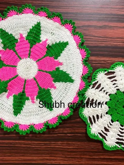 A pair of round crochet doilies, one large and one small, featuring a vibrant pink, green, and white floral pattern.
