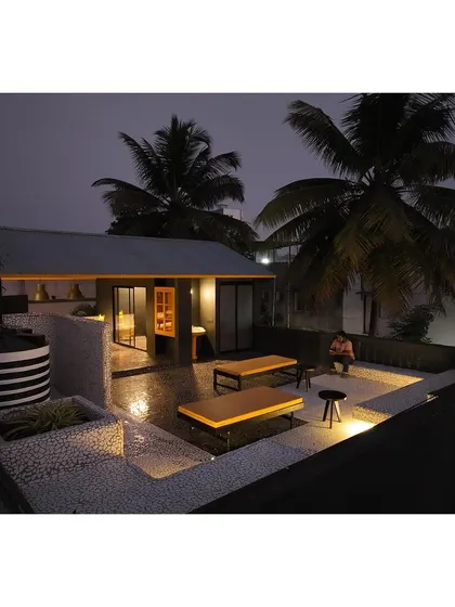 The rooftop extension of our Thirdspace Co-Living facility at night. This communal area includes a kitchen, dining space, and an expansive terrace, providing a shared social hub for the resident architects and interns.