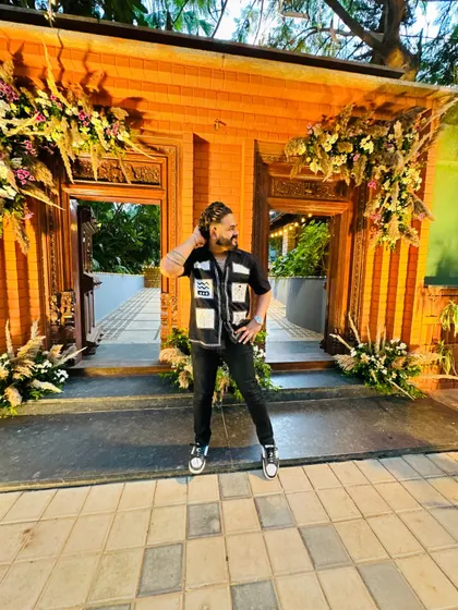 Posing at a beautifully decorated wedding venue. The ambiance is key, and my music is designed to complement it perfectly.