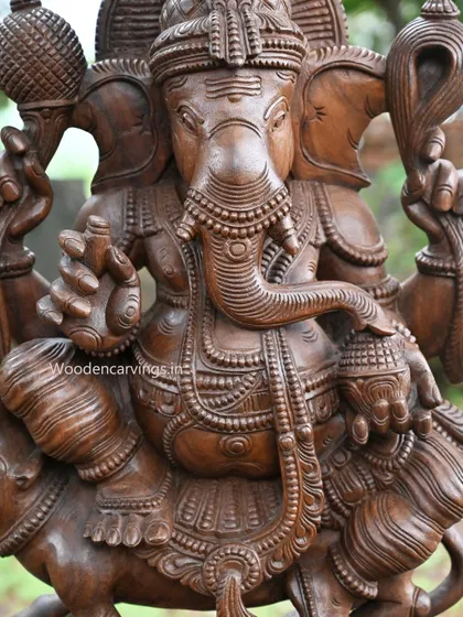 A close-up of the face and trunk of the Lambodara Ganapathy, showcasing the fine carving work.