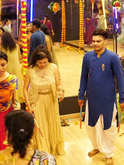 Participants in traditional attire learning a group formation for a Garba performance. We help coordinate outfits and formations for a polished look.