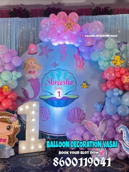 A closer look at our mermaid theme, showing the custom backdrop with an illustrated clamshell and various sea creature cutouts.