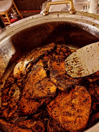 A serving of our delicious Tandoori Seer Fish in a traditional chafing dish, ready to be served at a Mehandi function.