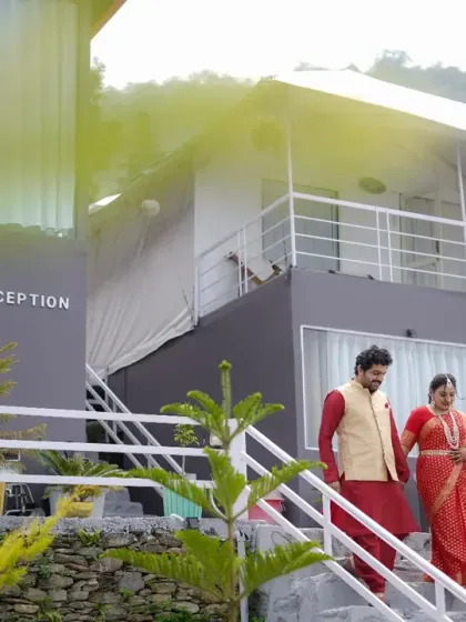 Descending the stairs at their destination wedding venue. The natural light and lush surroundings create a beautiful, candid frame for this couple's story.