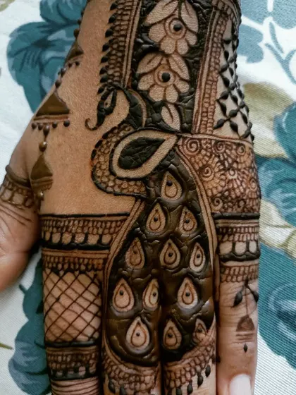 'The mehendi on my hands is blooming with my beloved's love.' A beautiful peacock design perfect for celebrating Teej, a festival of love and marriage.