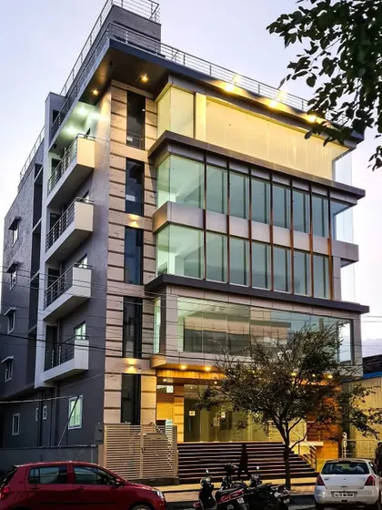 An evening shot of the HSR Layout commercial building, emphasizing the facade lighting and its visual impact on the streetscape.