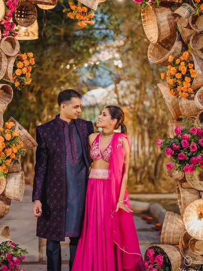 We love crafting unique design elements that reflect our couples' personalities. This stunning Sangeet entrance arch was made from woven baskets and bright florals, creating an unforgettable welcome for guests.