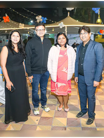 Friends and family gather for a photo at the outdoor section of the party, showing the versatility of the space for both indoor and outdoor celebrations.