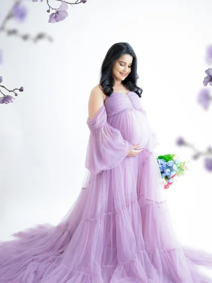 A duplicate of image 39, this dreamy portrait features a mom-to-be in a flowing lavender gown, surrounded by matching purple flowers.